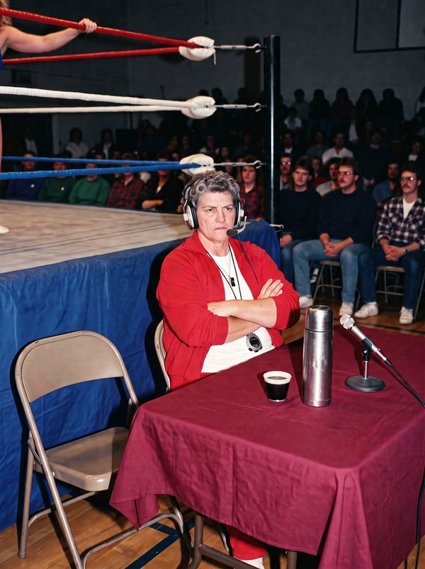 Iron Irma at the broadcast desk, arms folded